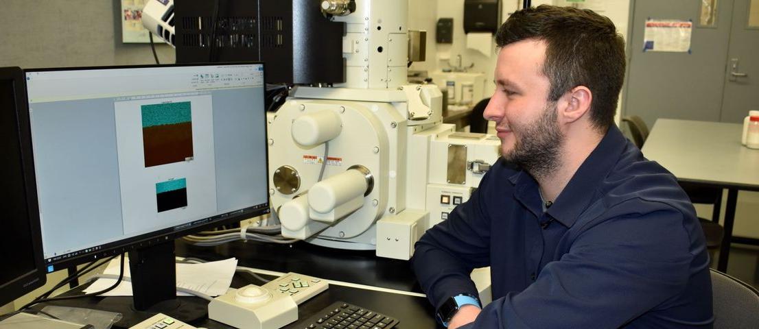Student conducting research on a scanning electron microscope